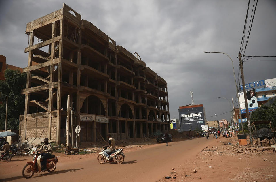 Few venture in the normally busy streets of Burkina Faso's capital Ouagadougou Friday Sept. 30, 2022. Residents say gunfire rang out early in the morning and the state broadcaster has gone off the air, fueling fears that another coup is underway. The developments Friday come just after coup leader-turned-president Lt. Col. Paul Henri Sandaogo Damiba returned from a trip to the U.N. General Assembly. (AP Photo/Sophie Garcia)