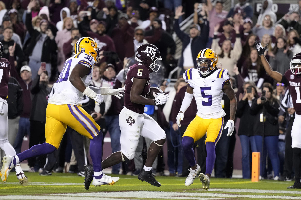 Texas A&M running back Devon Achane (6) crosses the goal line for a touchdown against LSU on Saturday, Nov. 26, 2022, in College Station, Texas. (AP Photo/Sam Craft)