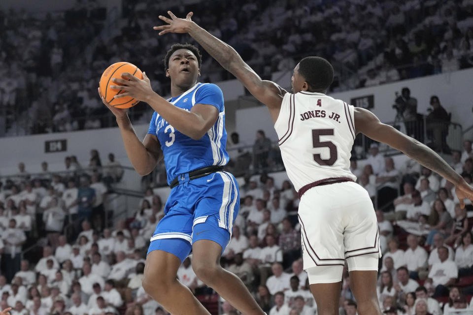 Mississippi State guard Shawn Jones Jr. (5) attempts to block a shot by Kentucky guard Adou Thiero (3) during the second half of an NCAA college basketball game Tuesday, Feb. 27, 2024, in Starkville, Miss. (AP Photo/Rogelio V. Solis)