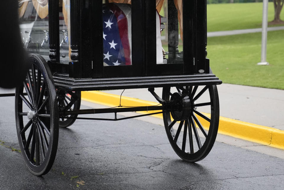 Airman Roger Fortson's casket is carried away during the funeral for Fortson at New Birth Missionary Baptist Church, Friday, May 17, 2024, in Stonecrest, Ga. (AP Photo/Brynn Anderson)