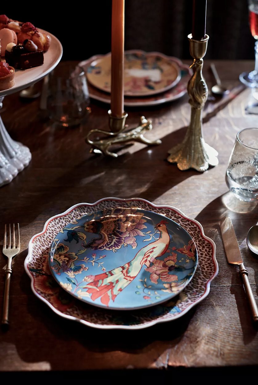 House of Hackney Dessert Plate in blue with bird on table with candle sticks (Photo via Anthropologie)