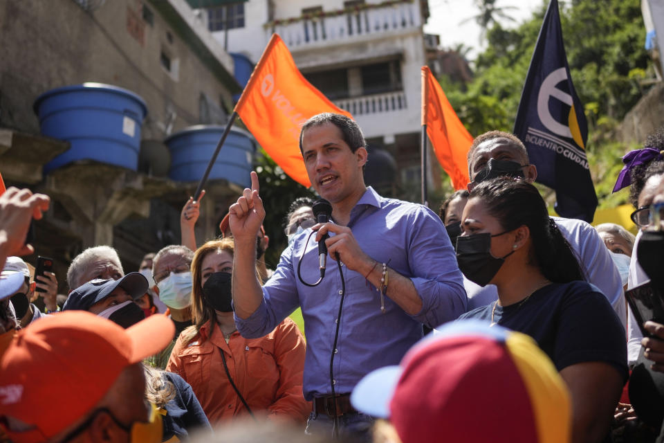 FILE - Venezuela opposition leader Juan Guaidó speaks to residents to present his unity plan to Venezuelans in Maiquetia, Venezuela, Feb. 19, 2022. A group of opponents of Venezuelan President Nicolas Maduro is looking to strip Guaidó of his authority as the internationally recognized head of the country's so-called interim government. Three of the four major opposition parties are expected to vote Thursday, Dec. 22, on the proposal to replace Guaidó with a horizontal style of leadership by committee. (AP Photo/Matias Delacroix, File)