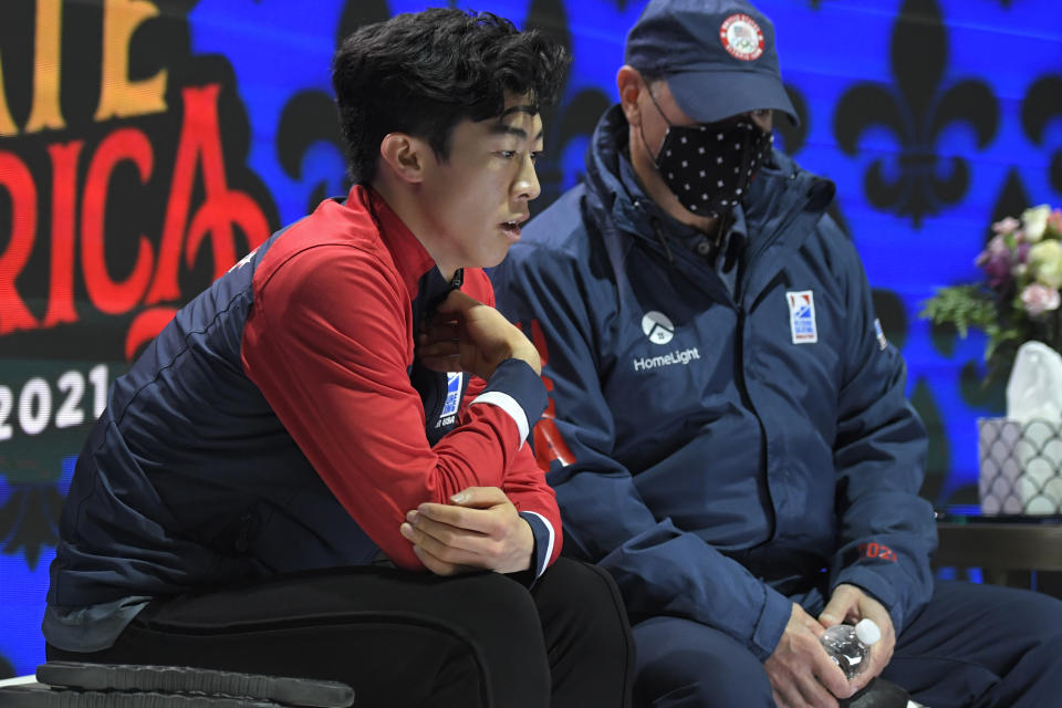 Nathan Chen watches his scores come in after performing during the men's short program at the Skate America figure skating event Friday, Oct. 22, 2021, in Las Vegas. (AP Photo/David Becker)