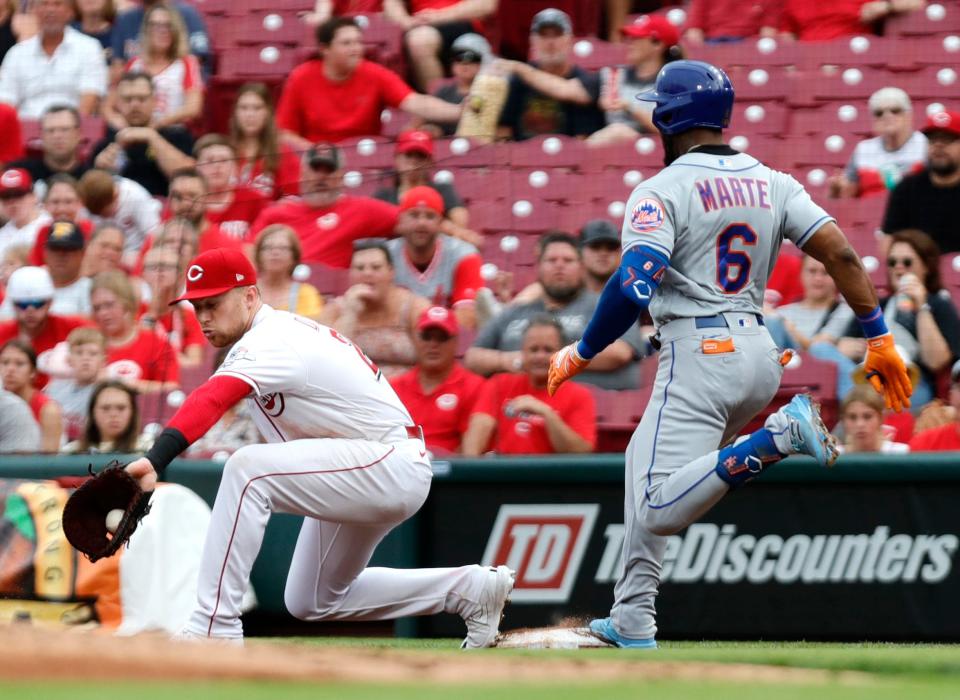 Jul 6, 2022; Cincinnati, Ohio, USA; New York Mets right fielder Starling Marte (6) is safe at first for a single against Cincinnati Reds first baseman Brandon Drury (22) during the third inning at Great American Ball Park. Mandatory Credit: David Kohl-USA TODAY Sports