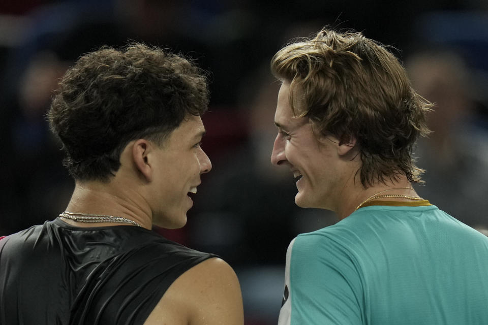 Sebastian Korda of the United States, right, chats with his compatriot Ben Shelton after beating him in the men's singles quarterfinal match of the Shanghai Masters tennis tournament at Qizhong Forest Sports City Tennis Center in Shanghai, China, Thursday, Oct. 12, 2023. (AP Photo/Andy Wong)