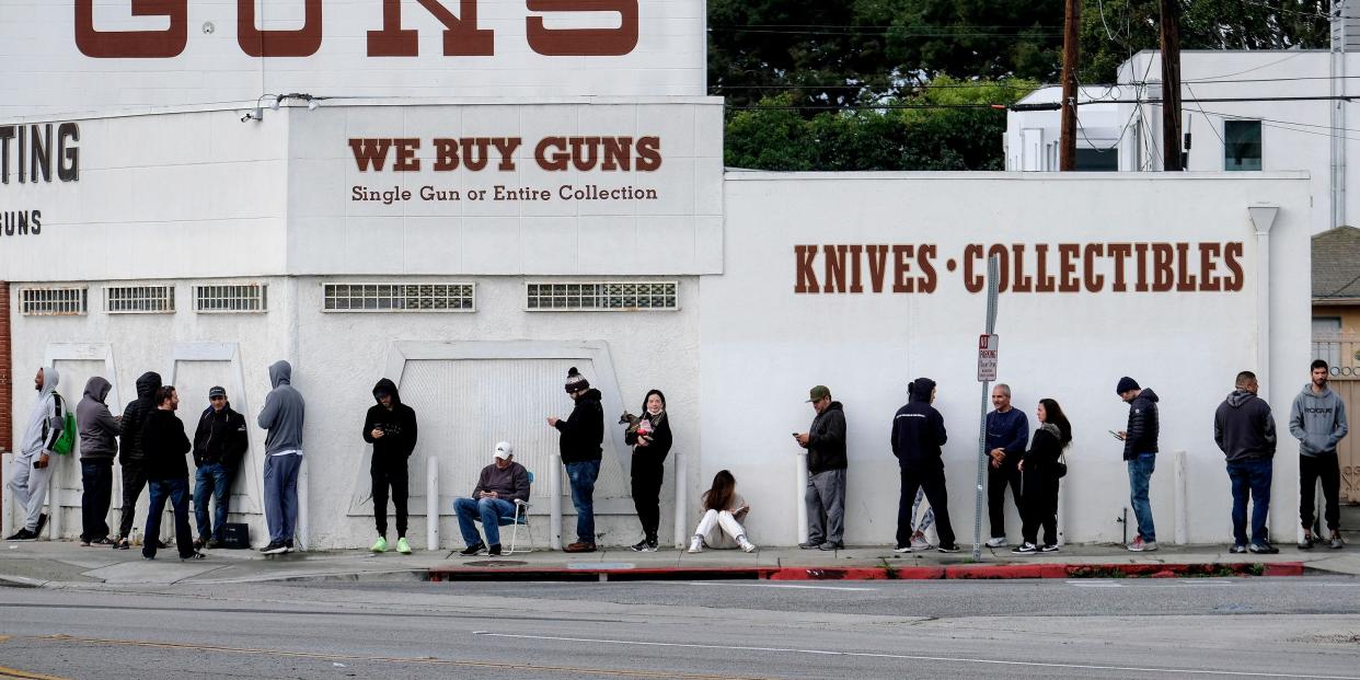 FILE - In this March 15, 2020, file photo, people wait in a line to enter a gun store in Culver City, Calif. The coronavirus pandemic has much of the world contemplating an existential question amid a growing number of stay-at-home orders, with only "essential" service providers allowed to go to their jobs. As U.S. states enact sweeping stay-at-home orders, there is lots of agreement on what's essential, but some have their own notions. A few are eyebrow raisers. Among them are guns, golf and cannabis. Most lists, being compiled by governors and others, capture the basics of what's essential. (AP Photo/Ringo H.W. Chiu, File)