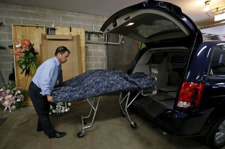 Glueckert Funeral Home Funeral director John Glueckert removes the remains of an abandoned baby from a hearse that was claimed from the Cook County Medical Examiner's office in Arlington Heights, Illinois, June 11, 2015. REUTERS/Jim Young