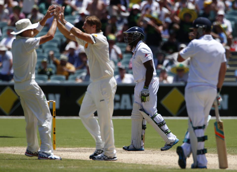 England's Michael Carberry (2nd R) walks off the field after his dismissal, as Australia's Shane Watson (2nd L) and Ryan Harris (L) celebrate, during the third day of the second Ashes test cricket match at the Adelaide Oval December 7, 2013.
