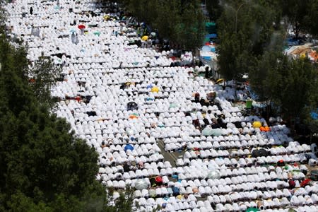 Muslim pilgrims pray outside Namira Mosque on the plains of Arafat during the annual haj pilgrimage, outside the holy city of Mecca