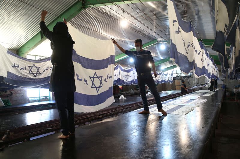 Large flag factory creates U.S. and Israeli flags for Iranian protesters to burn in Khomein City