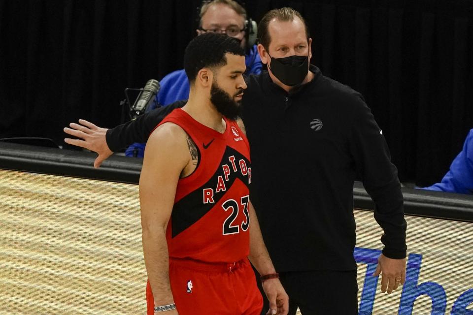 Toronto Raptors head coach Nick Nurse talks to Fred VanVleet during the first half of an NBA basketball game against the Milwaukee Bucks Thursday, Feb. 18, 2021, in Milwaukee. (AP Photo/Morry Gash)