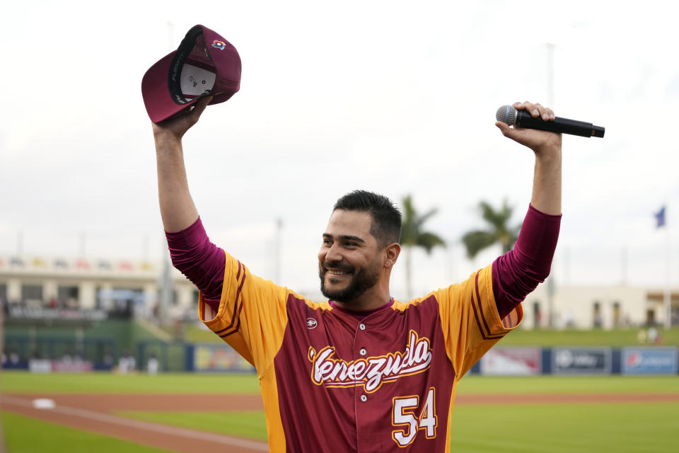 Venezuela's pitcher Martin Perez (54) waves after singing the Venezuelan national anthem before an exhibition baseball game between Venezuela and the Houston Astros, Wednesday, March 8, 2023, in West Palm Beach, Fla. (AP Photo/Lynne Sladky)