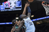 Washington Wizards guard Bilal Coulibaly (0) and Memphis Grizzlies forward Wenyen Gabriel (32) reach for a rebound during the first half of an NBA basketball game Tuesday, March 12, 2024, in Memphis, Tenn. (AP Photo/Nikki Boertman)