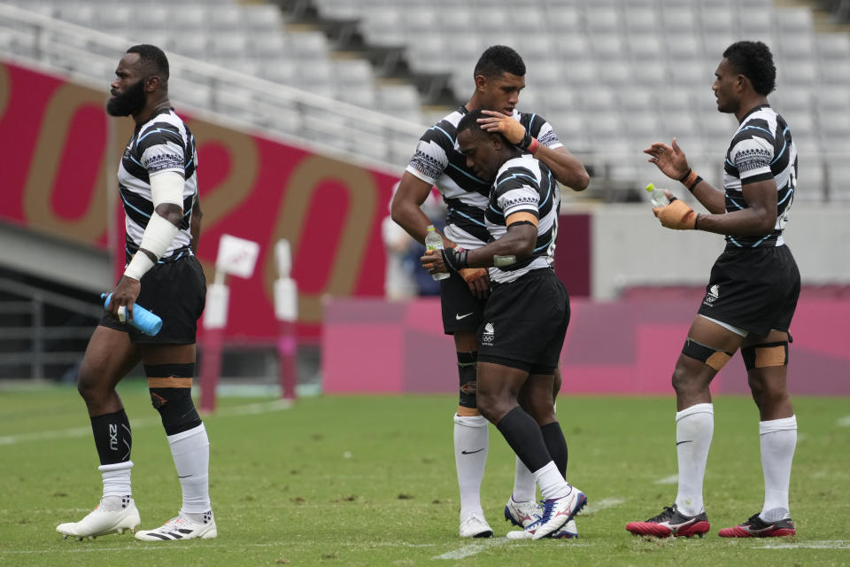 Fiji players embrace after defeating Argentina in their men's rugby sevens semifinal match at the 2020 Summer Olympics, Wednesday, July 28, 2021 in Tokyo, Japan. (AP Photo/Shuji Kajiyama)