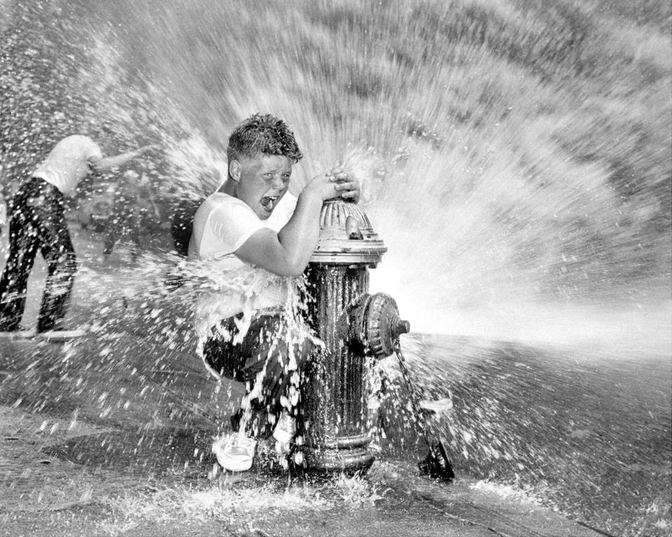 July 01, 1959:  Youngster playing in water from fire hydrant. Police are waging campaign against indiscriminate opening of hydrants since it reduces water pressure and poses a threat to fire fighters.  (Photo by NY Daily News Archive via Getty Images)