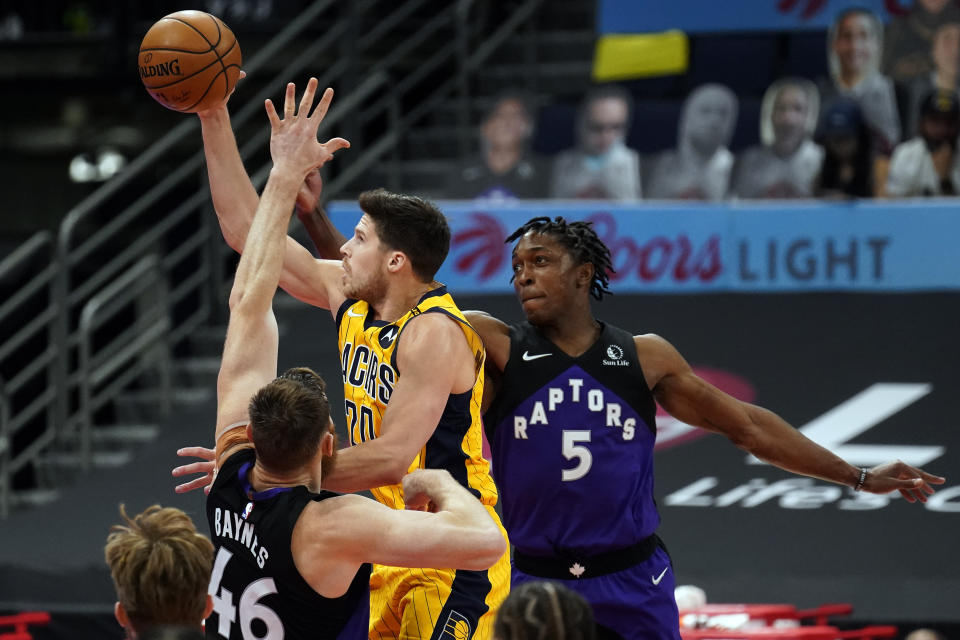 Indiana Pacers forward Doug McDermott (20) puts up a shot between Toronto Raptors center Aron Baynes (46) and forward Stanley Johnson (5) during the second half of an NBA basketball game Sunday, May 16, 2021, in Tampa, Fla. (AP Photo/Chris O'Meara)