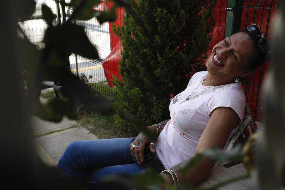 In this Aug. 17, 2019 photo, trans rights activist Kenya Cuevas smiles while visiting with a friend at her home in Chalco, Mexico. Cuevas said she is willing to endure the death threats if it means she can help secure a safer world for Mexico's trans community. "If I don't do it, the government isn't going to do it," Cuevas said. "And if I wait for the government to do it, how many more people are going to be killed?"( AP Photo/Ginnette Riquelme)