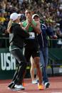 <p>Ashton Eaton celebrates with his girlfriend Brianne Theisen (L) and mother Roslyn Eaton (R) after breaking the world record in the men’s decathlon after competing in the 1500 meter run portion during Day Two of the 2012 U.S. Olympic Track & Field Team Trials at Hayward Field on June 23, 2012 in Eugene, Oregon. (Photo by Christian Petersen/Getty Images) </p>