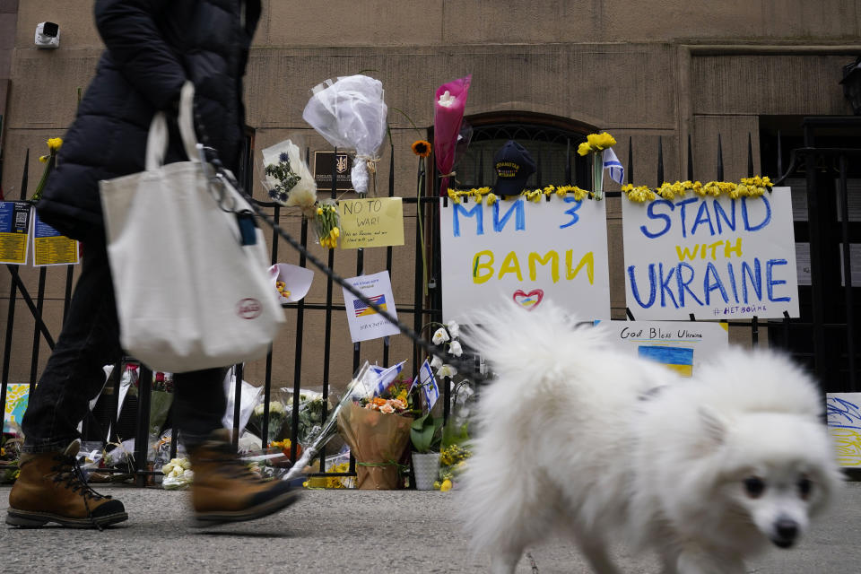 Signs and flowers of support adorn the gates of the Ukrainian Mission to the United Nations in New York, Tuesday, March 1, 2022. (AP Photo/Seth Wenig)