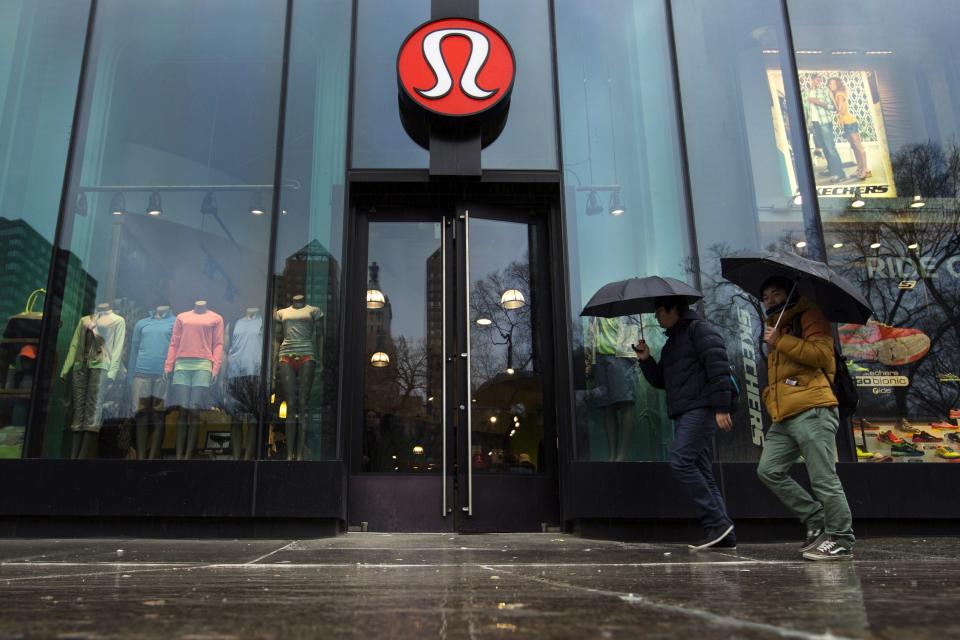 Pedestrians walk past a Lululemon Athletica store in New York, in this March 19, 2013, file photo. Premium yogawear retailer Lululemon Athletica Inc, still September 12, 2013, sending its shares lower. REUTERS/Lucas Jackson/Files (UNITED STATES - Tags: BUSINESS FASHION TEXTILE LOGO)