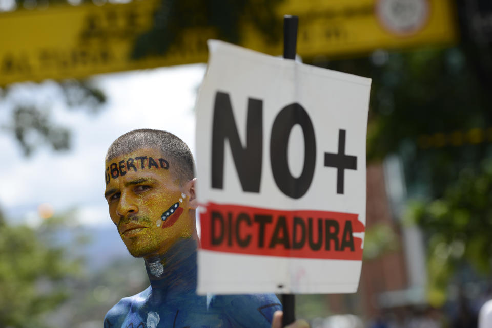 A man holding a sign with a message that reads in Spanish: "No more dictatorship," takes part in a demonstration led by opposition politician Juan Guaido, who’s urging masses into the streets to force President Nicolas Maduro from power, in Caracas, Venezuela, Saturday, Nov. 16, 2019. Guaido called nationwide demonstrations to re-ignite a campaign against Maduro launched in January that has lost steam in recent months. (AP Photo/Matias Delacroix)