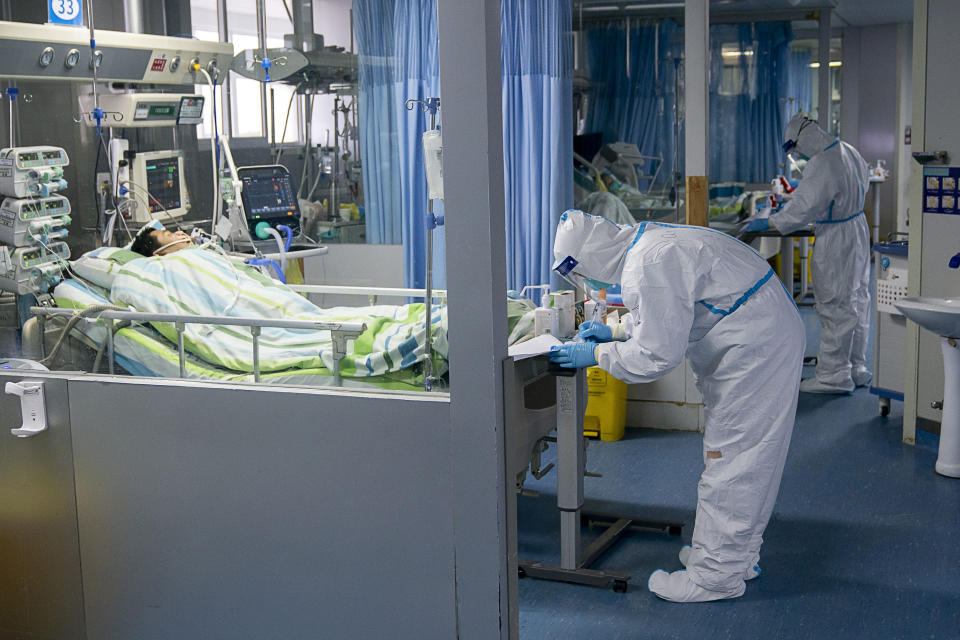 FILE - In this Jan. 24, 2020, file photo released by China's Xinhua News Agency, a medical worker attends to a patient in the intensive care unit at Zhongnan Hospital of Wuhan University in Wuhan in central China's Hubei Province. A 10-member team of international researchers from the World Health Organization hopes to find clues as to the origin of the coronavirus pandemic in the central Chinese city of Wuhan where the virus was first detected in late 2019. (Xiong Qi/Xinhua via AP, File)