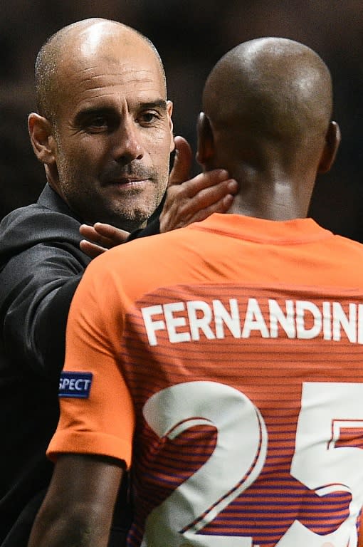 Manchester City's Spanish manager Pep Guardiola (L) congratulates midfielder Fernandinho following their UEFA Champions League match against Celtic