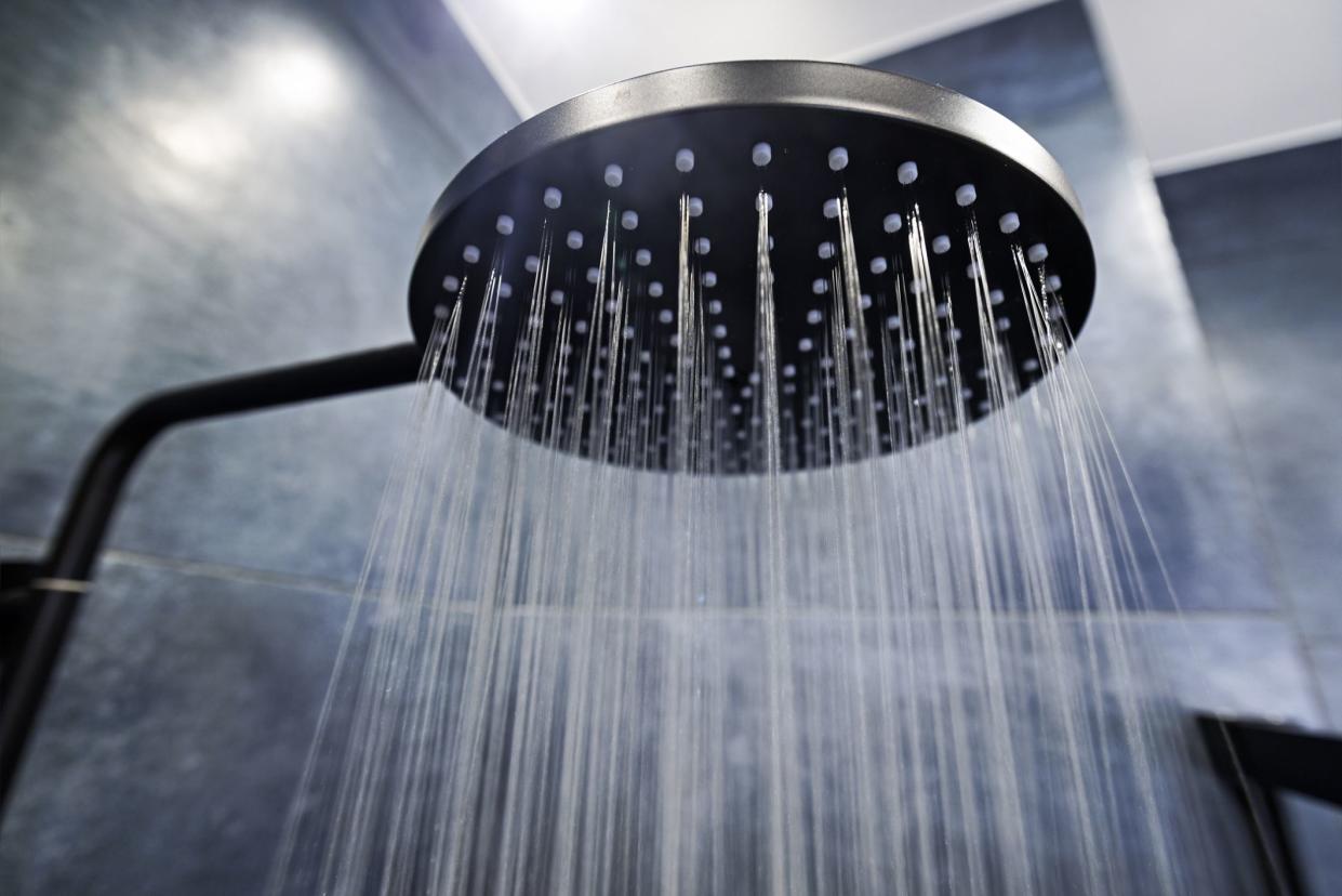 Modern luxury bathroom. Water running from a black rain shower head.Canon R5.