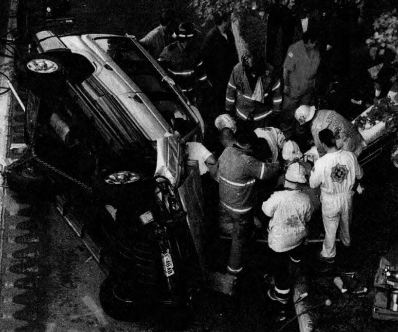 Rescuers extract a victim from a vehicle that drove off the Interstate 287 overpass at Whitman Avenue in Edison on Tuesday, Sept. 22, 1998.