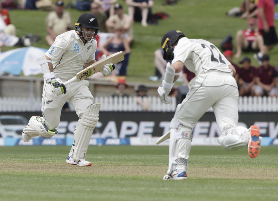 New Zealand's Tom Latham, left, runs a single with teammate Kane Williamson during play on day one of the second cricket test between England and New Zealand at Seddon Park in Hamilton, New Zealand, Friday, Nov. 29, 2019. (AP Photo/Mark Baker)