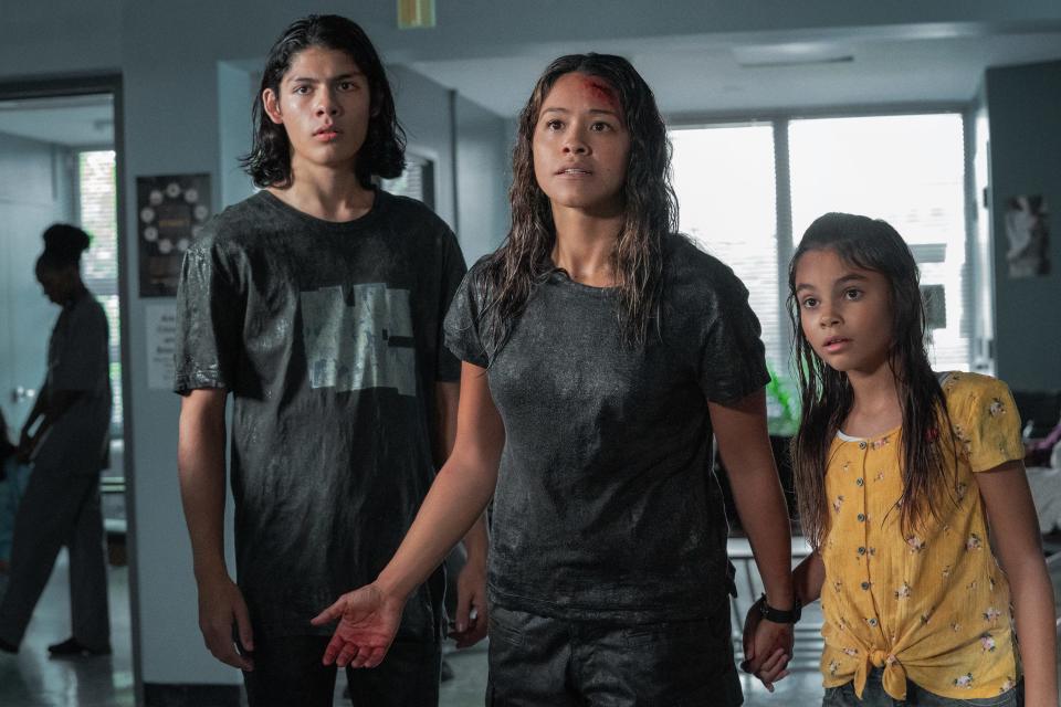 Gina Rodriguez (center) plays a mom keeping her kids (Lucius Hoyos and Ariana Greenblatt) safe amid a mysterious apocalypse in "Awake."