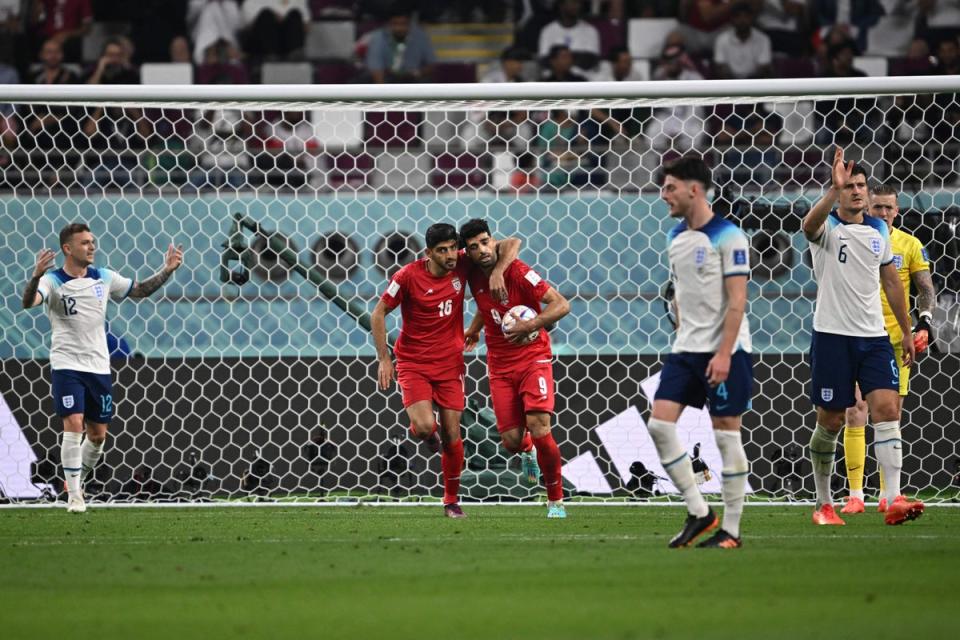 As Taremi celebreates, the England players around him react (AFP/Getty)