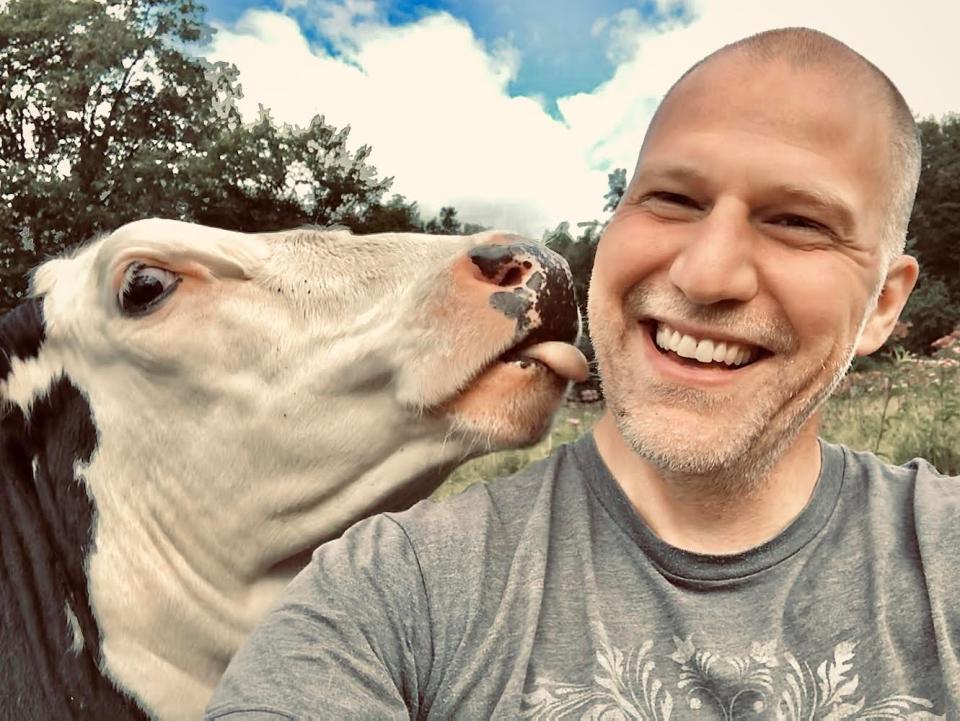 Michael Shank and rescue cow at his animal sanctuary in southern Vermont.