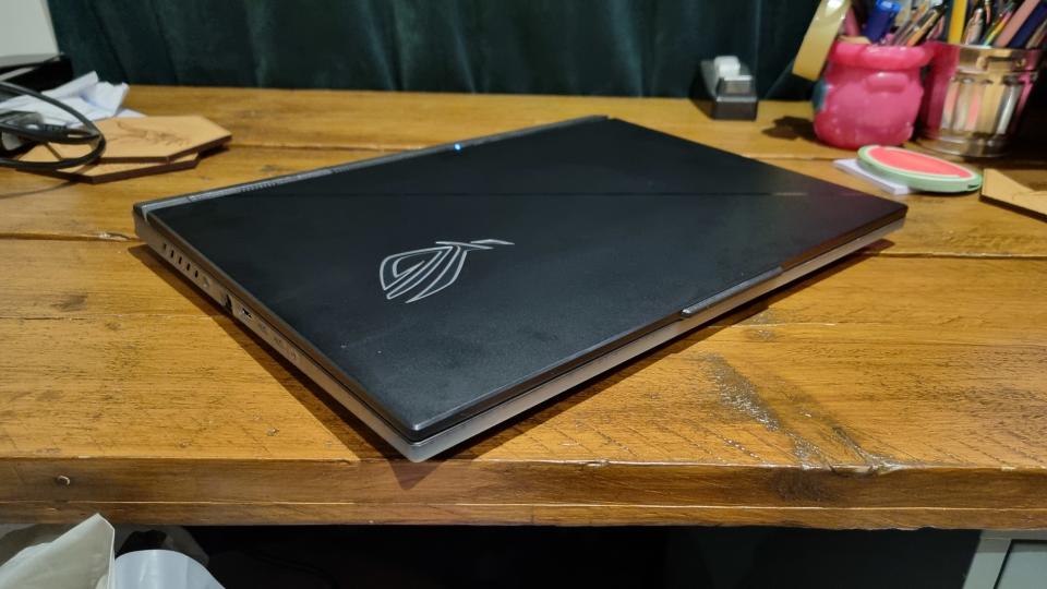 The Asus ROG Strix Scar 18, closed on a wooden desk