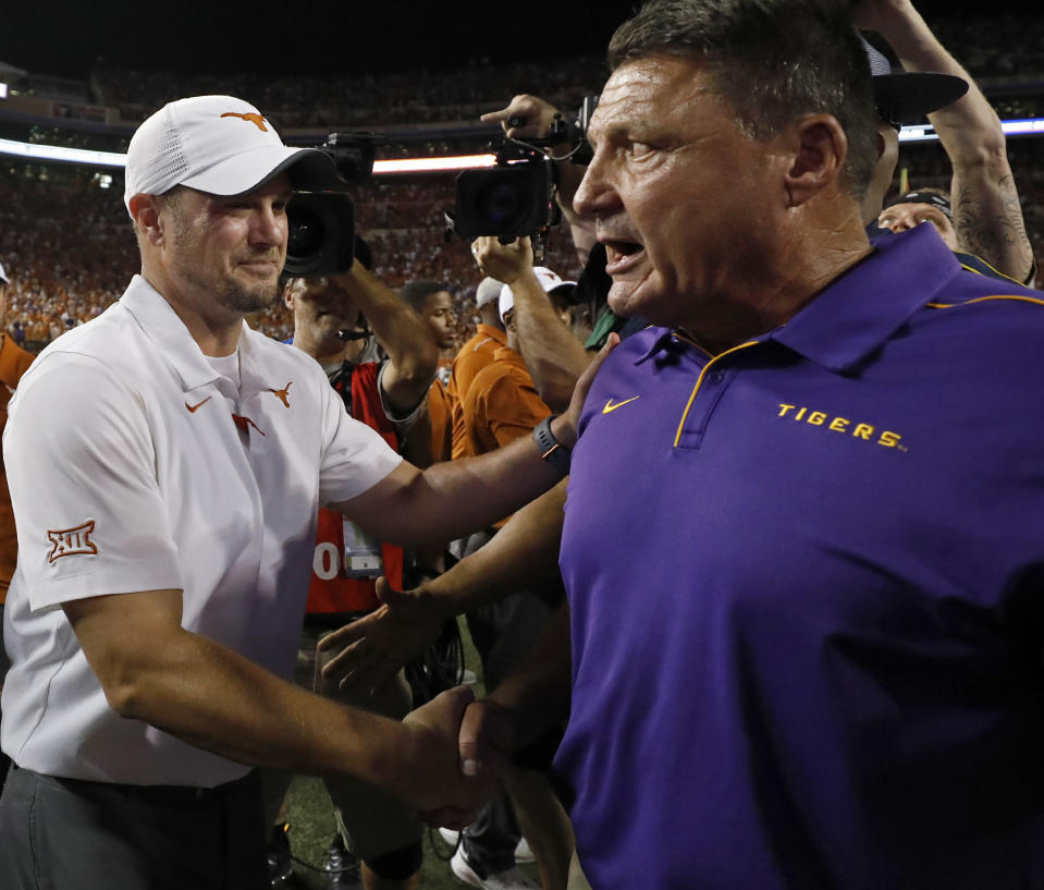 Texas Longhorns head coach Tom Herman (left) talks with LSU Tigers head coach Ed Orgeron after the game Saturday Sept. 7, 2019 at Darrell K Royal-Texas Memorial Stadium in Austin, Tx. LSU won 45-38. ( Photo by Edward A. Ornelas )