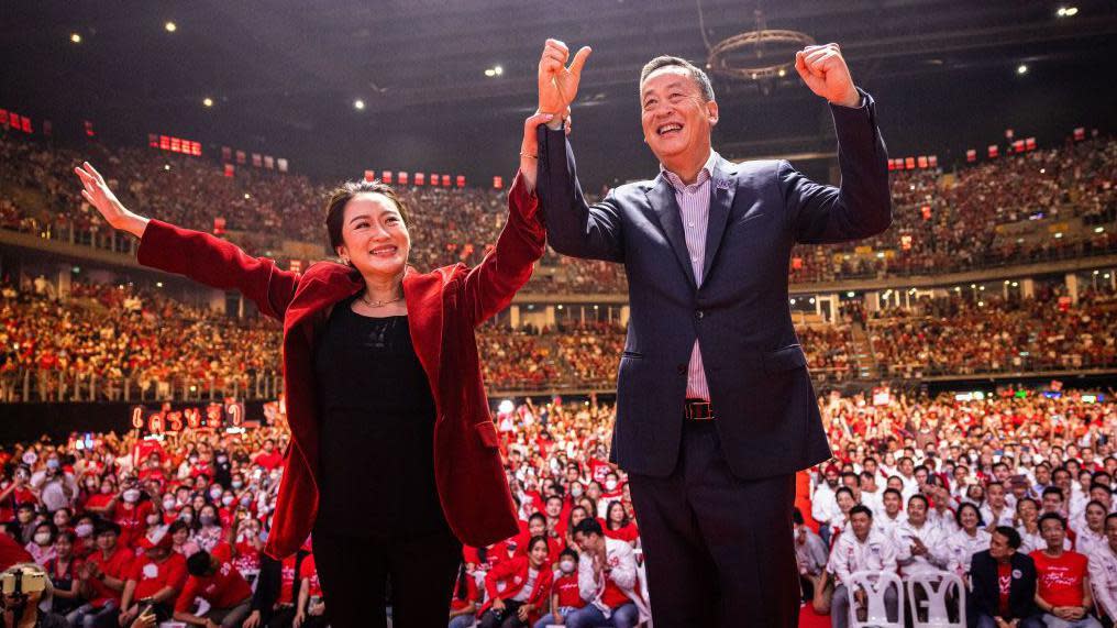 Paetongtarn Shinawatra and Srettha Thavisin, Prime Ministerial candidates for Thailand's Pheu Thai party, greet supporters during an election rally on May 12, 2023 in Bangkok.