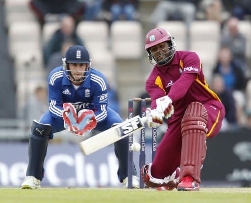 Dwayne Smith of the West Indies (R) hits a shot watched by England's wicketkeeper Craig Kieswetter. England beat the West Indies by 114 runs under the Duckworth/Lewis method