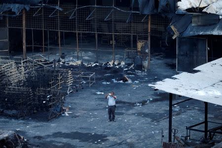 A plainclothes police officer works at the site of an explosion at a fireworks factory at Kosambi village in Tangerang, Indonesia Banten province, October 26, 2017. REUTERS/Beawiharta