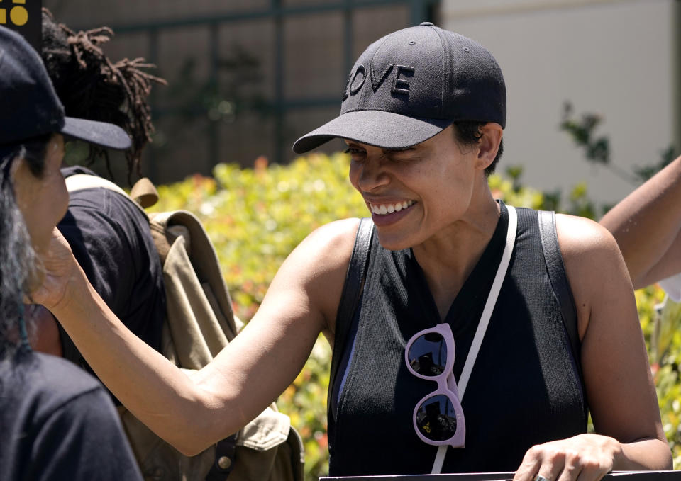 Actor Rosario Dawson attends a rally by striking writers and actors outside Warner Bros. studios in Burbank, Calif. on Friday, July 14, 2023. This marks the first day actors formally joined the picket lines, more than two months after screenwriters began striking in their bid to get better pay and working conditions and have clear guidelines around the use of AI in film and television productions.(AP Photo/Mark J. Terrill)