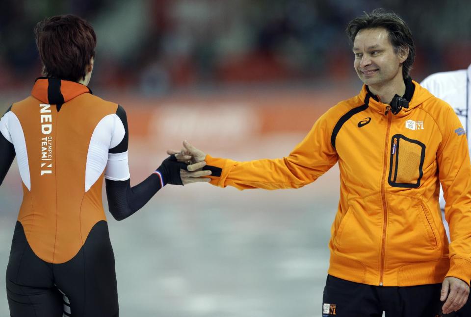 Gold medallist Jorien ter Mors of the Netherlands is congratulated by her coach Jeroen Otter, right, after she competed in the women's 1,500-meter speedskating race at the Adler Arena Skating Center at the 2014 Winter Olympics, Sunday, Feb. 16, 2014, in Sochi, Russia. (AP Photo/Patrick Semansky)