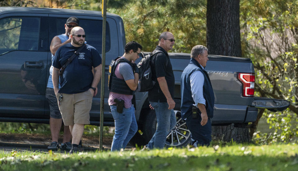 Police investigate the scene of a fatal shooting of a postal worker in front of a house on Suburban Ave. in Collier Township, Pa., outside of Pittsburgh, on Thursday, Oct. 7, 2021. (Andrew Rush/Pittsburgh Post-Gazette via AP)