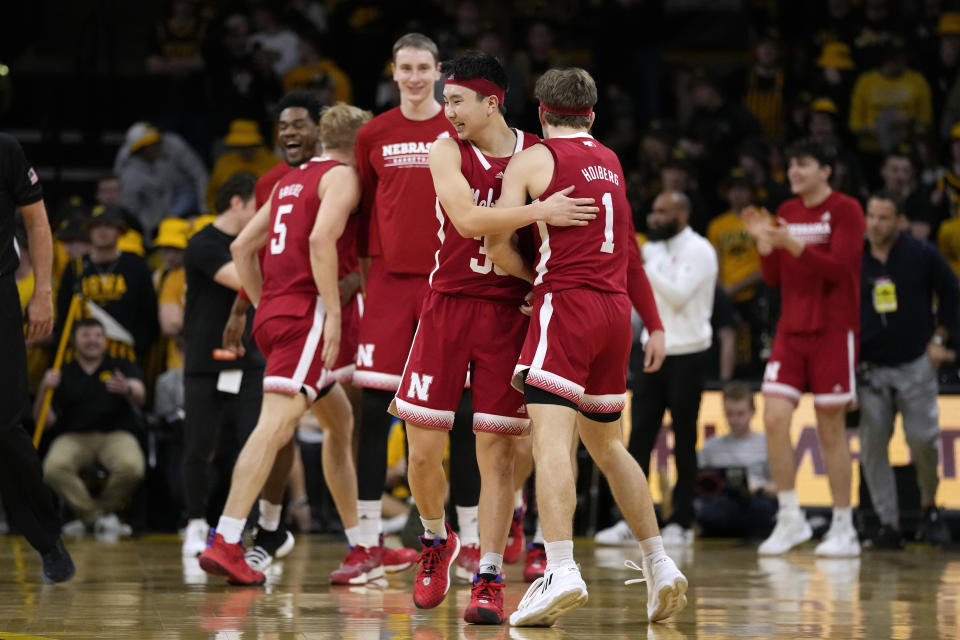 Nebraska guard Keisei Tominaga, center, celebrates with teammate guard Sam Hoiberg (1) after an NCAA college basketball game against Iowa, Sunday, March 5, 2023, in Iowa City, Iowa. Nebraska won 81-77. (AP Photo/Charlie Neibergall)