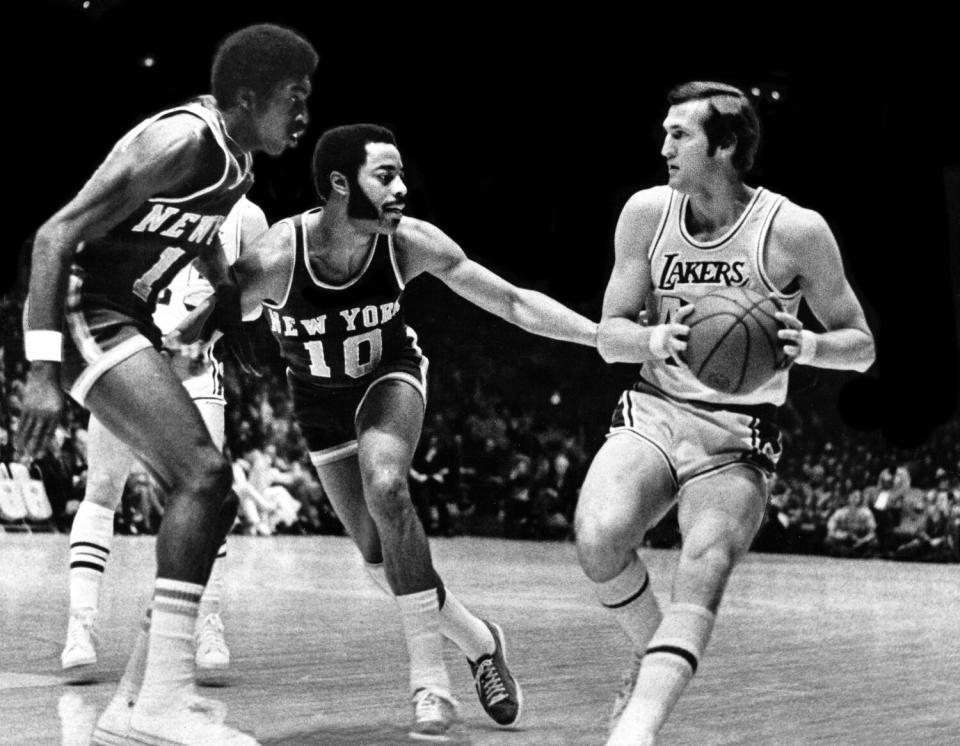 The Lakers' Jerry West dribbles and gets cut off by Knicks Earl Monroe and Walt Frazier during a game in 1973