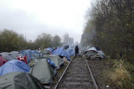 A migrants makeshift camp is set up in Calais, northern France, Saturday, Nov. 27, 2021. At the makeshift camps outside Calais, migrants are digging in, waiting for the chance to make a dash across the English Channel despite the news that at least 27 people died this week when their boat sank a few miles from the French coast. (AP Photo/Rafael Yaghobzadeh)