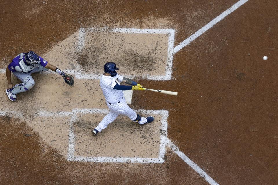 Milwaukee Brewers' Omar Narvaez hits a two-run home run during the sixth inning of a baseball game against the Colorado Rockies Sunday, June 27, 2021, in Milwaukee. (AP Photo/Morry Gash)