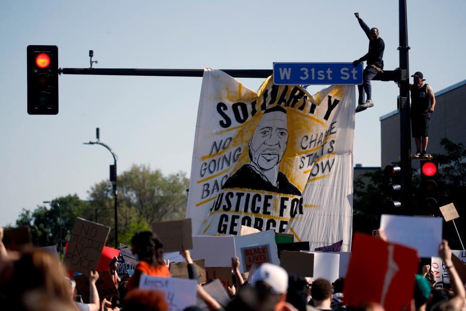 People react during a rally Saturday in Minneapolis. Protests continued following the death of George Floyd.