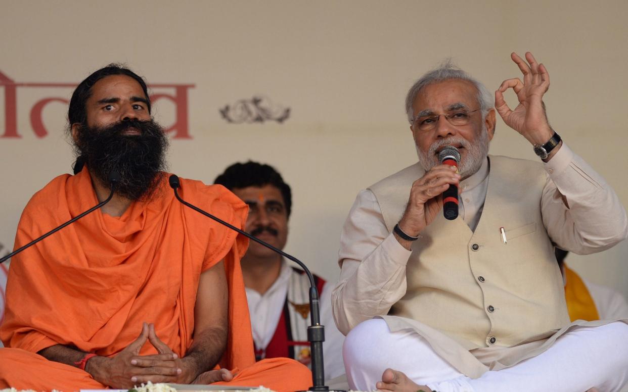 Indian prime minister Narendra Modi (right) with yoga guru Baba Ramdev  - Sajjad Hussain/AFP