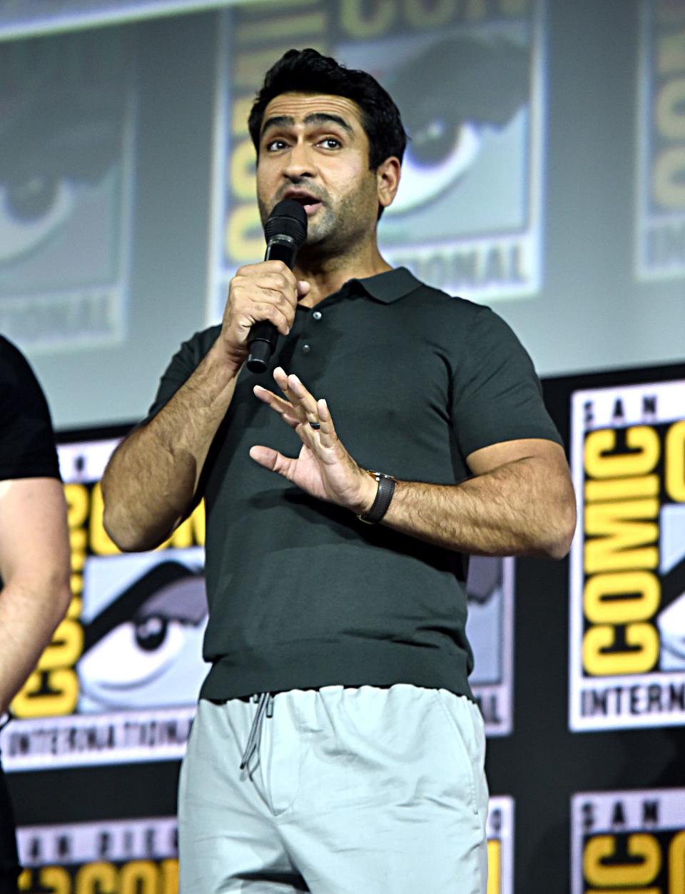 "Eternals" star Kumail Nanjiani speaking on stage at San Diego Comic-Con in 2019.