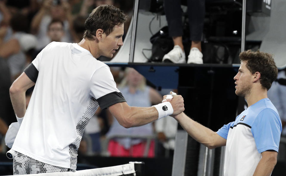 Tomas Berdych, left, of the Czech Republic is congratulated by Argentina's Diego Schwartzman after winning their third round match at the Australian Open tennis championships in Melbourne, Australia, Friday, Jan. 18, 2019. (AP Photo/Aaron Favila)