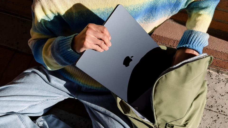 a top-down view of someone typing on an apple macbook pro